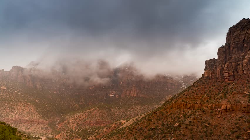 Stormy dark clouds over the red sandstone cliffs of Southern Utah - time lapse