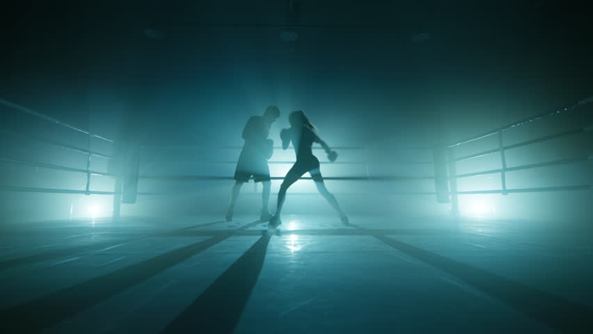 Close-up view of intensive training for gaining body strength. Unrecognized man and woman training in darkness. High quality 4k footage in cold teal blue foggy back light | Shutterstock HD Video #1099736417