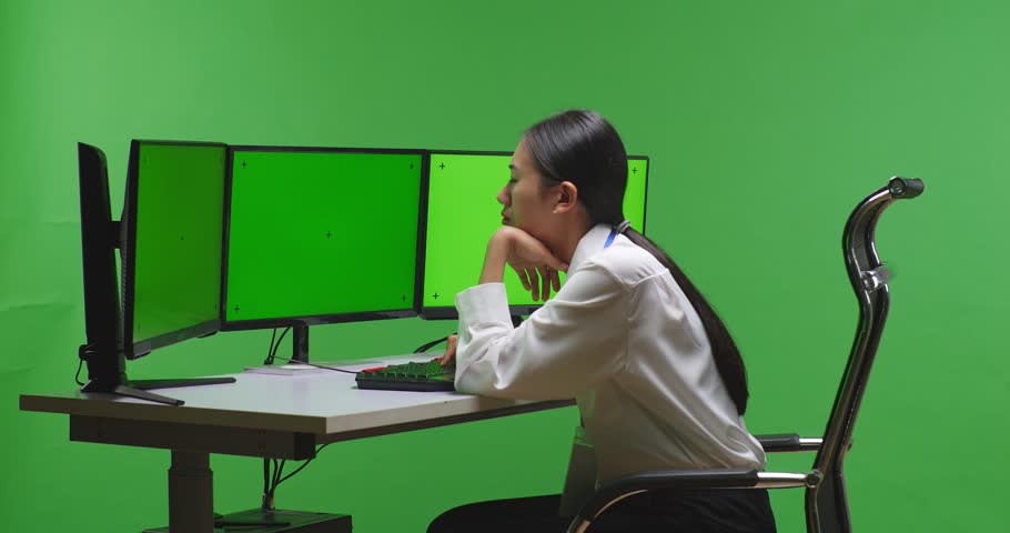 Side View Of Tired Asian Woman Yawning While Working With Mock Up Multiple Computer Monitor In Green Screen Studio
 | Shutterstock HD Video #1099738371