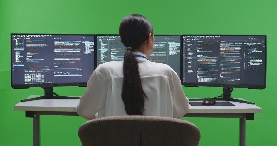 Back View Of Tired Asian Woman Developer Yawning While Write Code With Multiple Computer Screens In Green Screen Studio
 | Shutterstock HD Video #1099738375