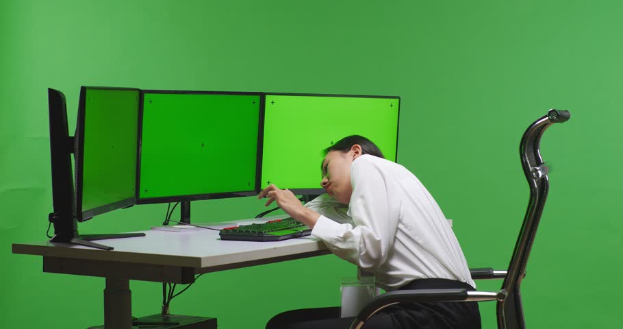Side View Of Asian Woman Boring While Working With Mock Up Multiple Computer Monitor In Green Screen Studio
 | Shutterstock HD Video #1099738377