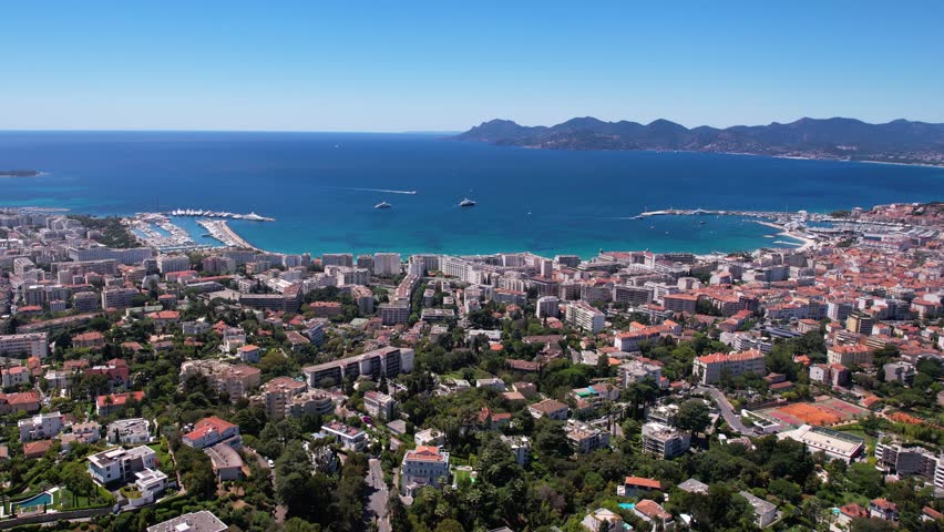 Aerial View of Cannes, France. Buildings, Harbor and Blue Mediterranean Sea Horizon Royalty-Free Stock Footage #1099741739