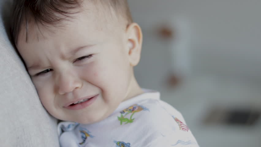 portrait of crying baby sleepy child in mom arms rubbing eyes making air and graces whims.mother caresses little cute toddler infant kid hand.nervous baby shaking milk teeth make grimaces Royalty-Free Stock Footage #1099742419