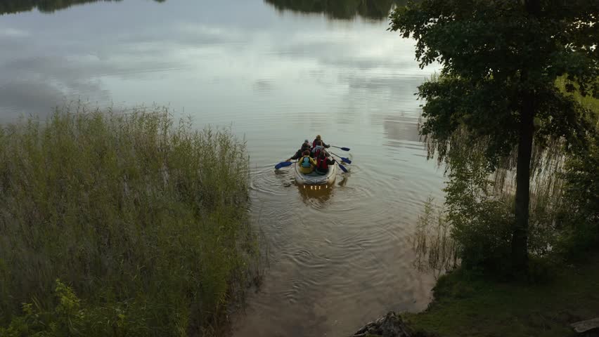 Group of people with a boat starting a journey on the lake