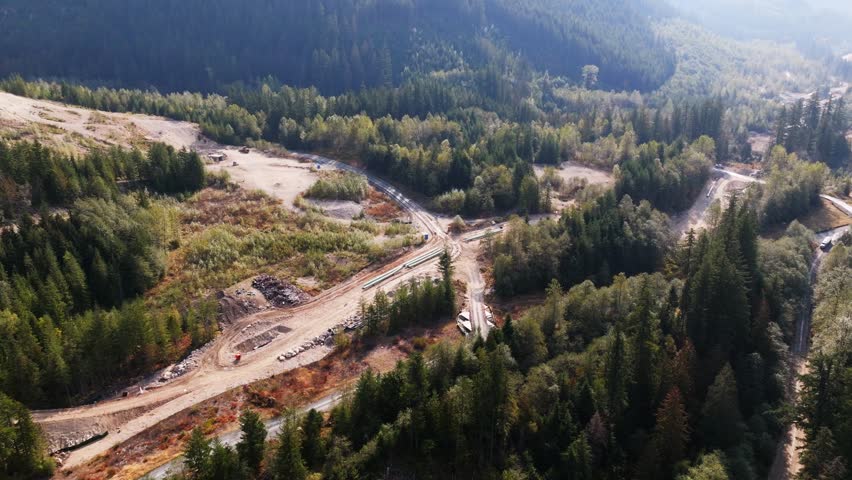 Construction of the TMX oil and gas pipeline in British Columbia Canada. Building an oil pipeline near a river.