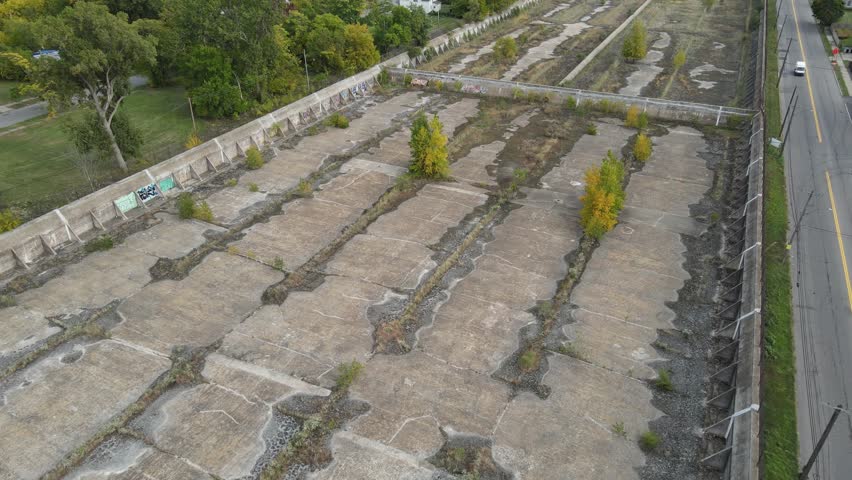Concrete water reservoir left abandoned in Detroit city, aerial view