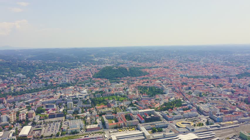 Inscription on video. Graz, Austria. The historic city center aerial view. Mount Schlossberg (Castle Hill). Lightning strikes the letters, Aerial View, Point of interest