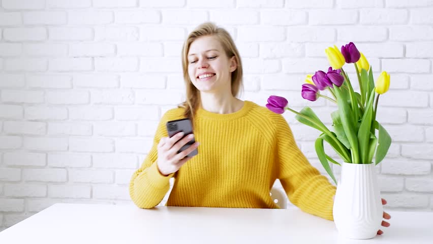 happy woman taking selfie with bouquet of yellow tulip flowers, spring holidays Royalty-Free Stock Footage #1099746099