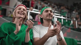 Love couple date at sport stadium. Happy fans cheer favorite team. Pair score win goal. Spectators support football game. Emotional soccer play. Smiling guy claps tribune. Enjoying fan applaud match. - Powered by Shutterstock - Get 15% off with code: PIKWIZARD15