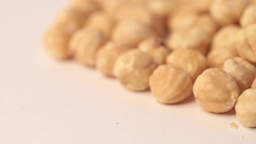 Close up on hazelnuts shot in a studio, no people are visible.