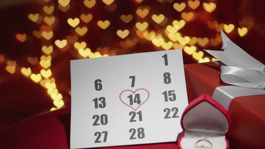 A gift for Valentines Day. Gift box on a red background with hearts. On the calendar, February 14 is the celebration of the event. Heart valentines. Hand and heart proposal concept with wedding ring.
