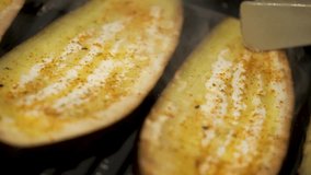 Close up video turning around grilled seasoned eggplant. Vegetarian diet.
