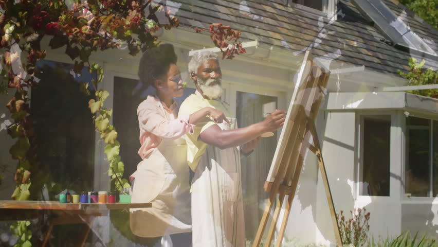 Animation of light spots over african american couple painting on easel in garden. Art, hobby and nature concept digitally generated video