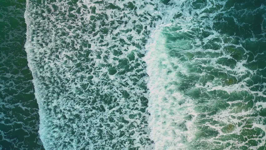 Beautiful texture of big power dark ocean waves with white wash. Aerial top view footage of fabulous sea tide on a stormy day. Drone filming breaking surf with foam in Vietnam ocean. Big swell in Asia | Shutterstock HD Video #1099756429