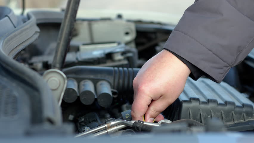 Man checking engine oil. Closeup shot | Shutterstock HD Video #1099756787