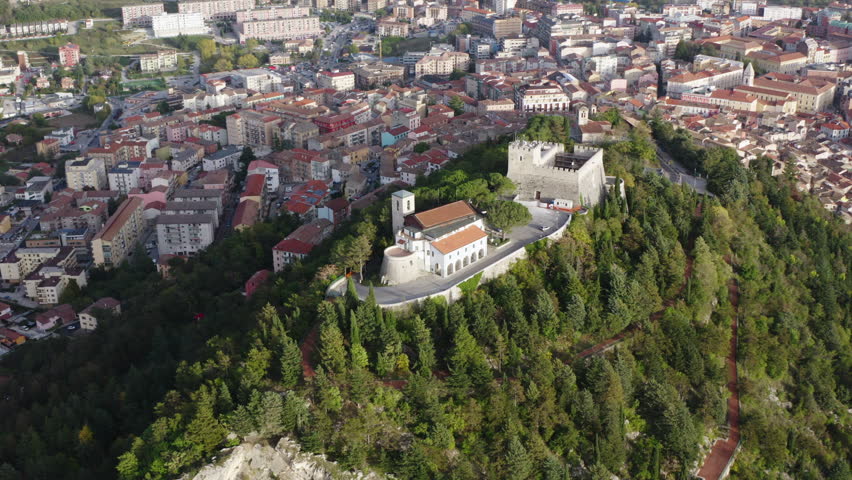 Medium aerial orbiting left shot of Monforte Castle in Campobasso with city in the background