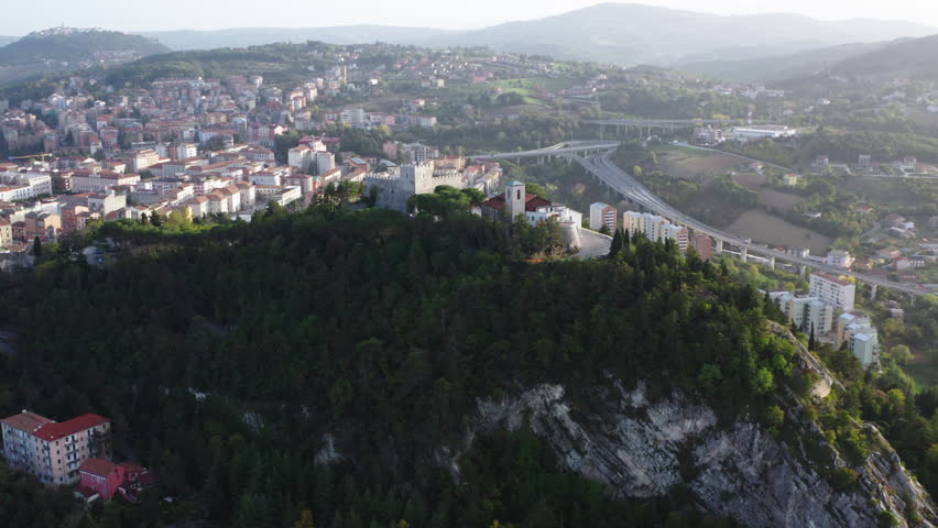 Wide aerial orbiting shot of Monforte Castle in Campobasso with city in the background
