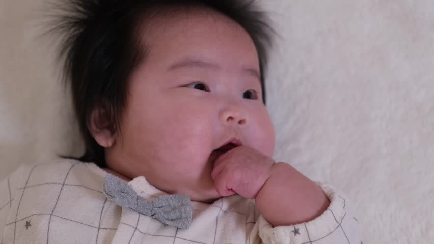 Close-up video of infant baby laughing face