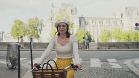 Attractive young girl cycling down the street in Paris