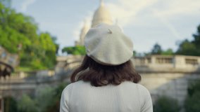 Young girl walking towards the Sacre Coeur in Paris