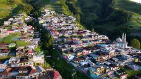Drone shot of beautiful scenery of village on the slope of mountain with view of terraced houses. Nepal Van Java, Indonesia