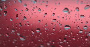 Rain Droplet on window with motion of water, Raining on window concept with selective focus, 4K V.D.O.