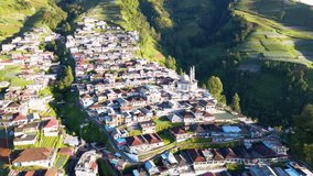 Aerial view of country houses built on the slopes of the mountain. The houses are terraced and colorful. Nepal Van Java on the slope of Sumbing Mountain - Indonesia