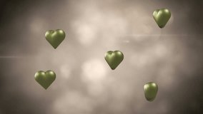 Animation of gold hearts over light spots and smoke. Valentine's day, love and celebration concept digitally generated video.