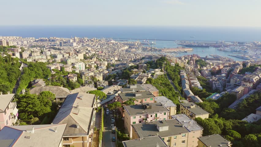 Inscription on video. Genoa, Italy. Central part of the city, aerial view. Ships in the port. Multicolored text appears and disappears, Aerial View