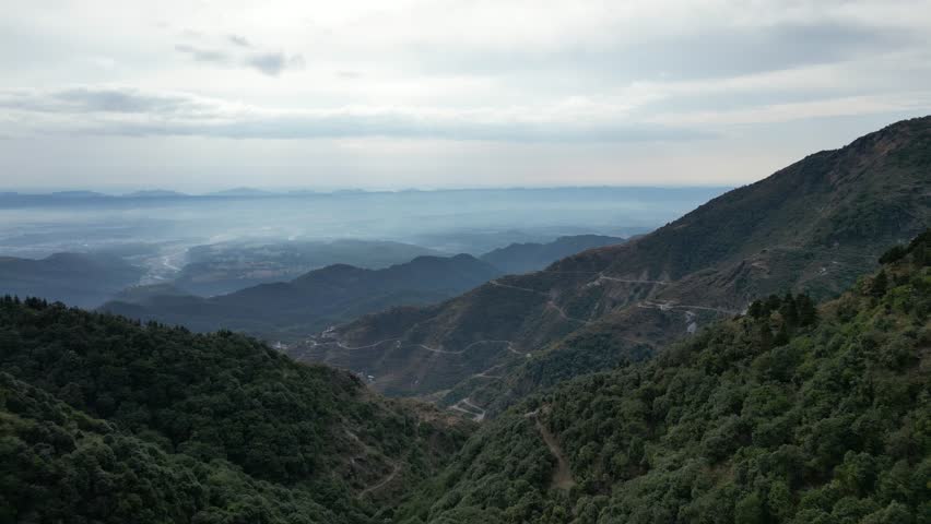 Aerial landscape view of Mussoorie hilltop peak in Uttarakhand, India with colorful buildings. Mussoorie Hill station near Dehradun in Uttarakhand Himalayan Range.