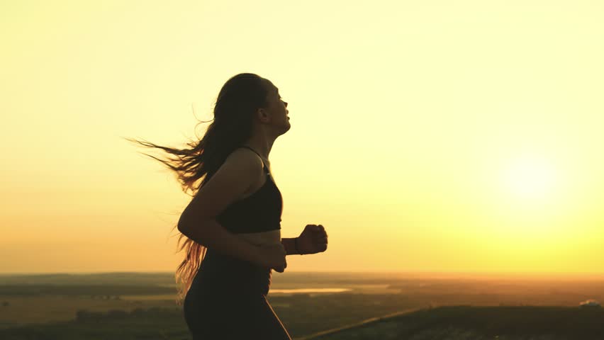 Young girl run sunset. active female lifestyle. women jogging sunset. leg cardio. healthy young woman running. sport jogging sun. leg training for sports competitions. fitness training dawn. | Shutterstock HD Video #1099792009