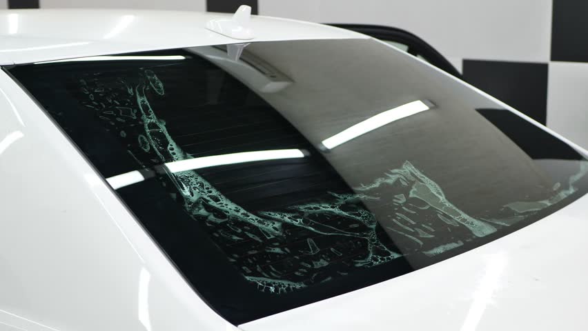 Car window tinting series: Installation of car window tinting. Detailing studio Royalty-Free Stock Footage #1099792257