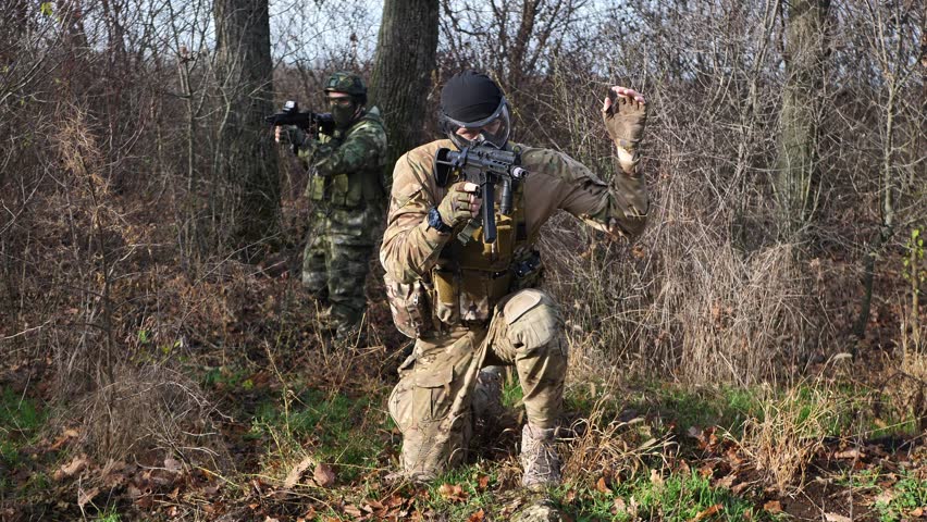 A group of soldiers in a war zone playing airsoft
