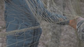 Nets for catching wild animals in the forest. Trapping game animals. Unraveling trapping nets. 4K 120fps video, ProRes 422, 10 bit ungraded C-LOG video