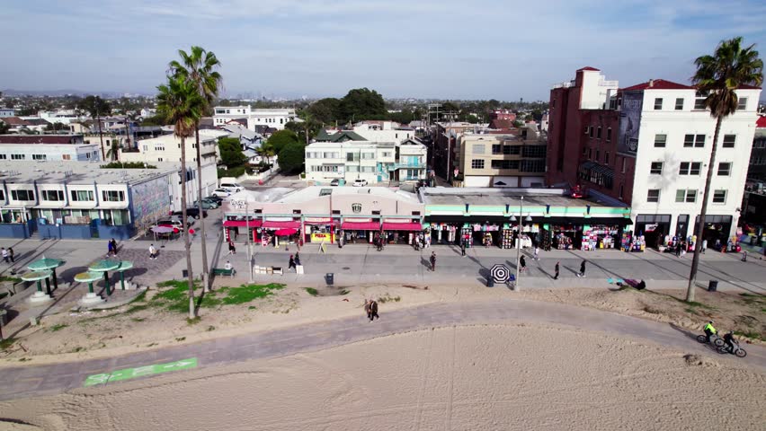 Drone trucks camera right over Venice Beach, California.