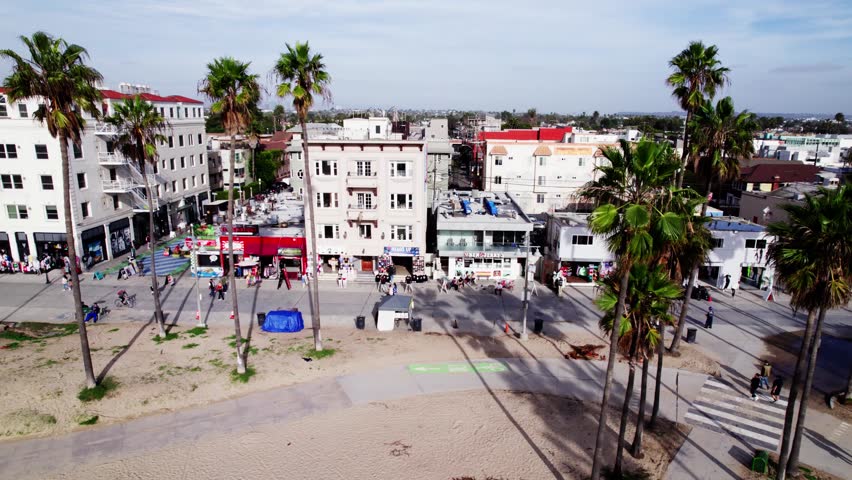 Drone trucks camera left over Venice Beach, California.