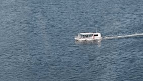 A Small yacht Floats on the Sea Surface of Dubai's creek, Arabian Sea, a top tourist attraction UAE, 4k Footage