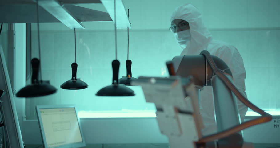 Engineer in protecting suit working in laboratory on computer | Shutterstock HD Video #1099801985