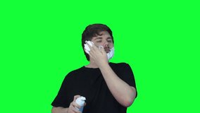 Funny young man applies lather before shaving face.green screen. Clip. chroma key