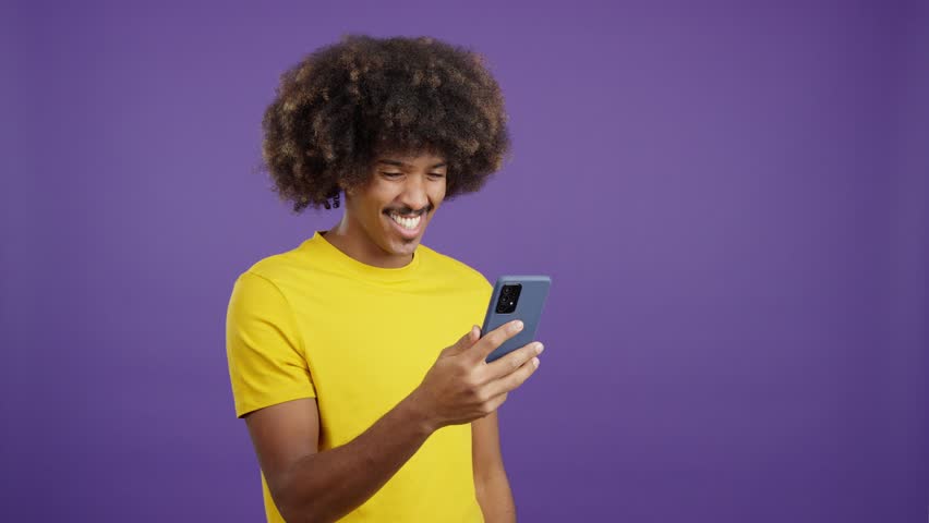 Happy african man smiling while using a mobile | Shutterstock HD Video #1099825159