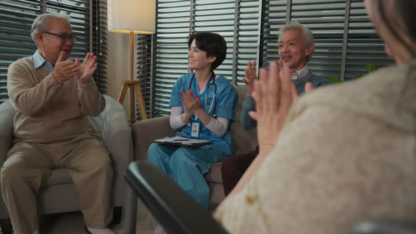 Happy of Asian senior people and young nurse applauding for oldman in group therapy session psychological support for elderly people in a community centre, sitting in a circle in a nursing home | Shutterstock HD Video #1099827003