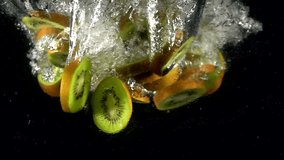 Super slow motion of falling fresh kiwi slice into splashing water. Fresh juice cooking concept. Filmed on high speed cinema camera, 4k 1000 fps. - Powered by Shutterstock - Get 15% off with code: PIKWIZARD15
