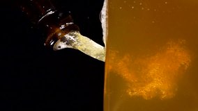 Super Slow Motion Shot of Beer Bubbles in glass at black background at 1000fps. High quality 4k video filmed on high speed camera