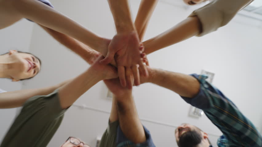 Bottom view of multiethnic people putting their hands together, unity, teamwork | Shutterstock HD Video #1099828387