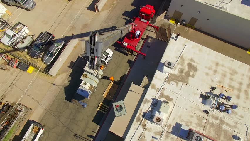 Crane lifting AC Unit onto Roof with Repair Techs Working Aerial Drone | Shutterstock HD Video #1099829481