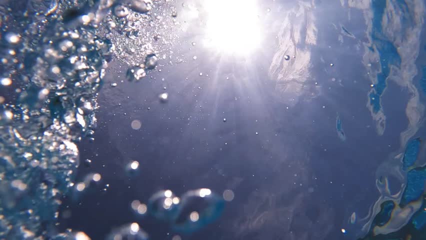 Underwater slow motion loop video of diver releasing air bubbles flowing towards sea surface in tropical exotic bay with deep blue waters | Shutterstock HD Video #1099830727
