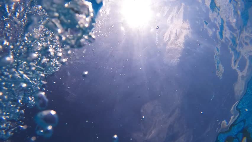 Underwater slow motion loop video of diver releasing air bubbles flowing towards sea surface in tropical exotic bay with deep blue waters | Shutterstock HD Video #1099830733