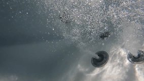 Underwater slow motion video of Jacuzzi jets releasing air bubbles perfect for massage spa and well being
