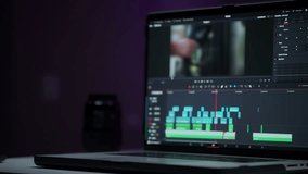 Monitor or display of the editor's laptop. Uses a computer to creatively create a video clip. Makes color correction of video content. A freelance colorist works at home in the studio. Cinematographer