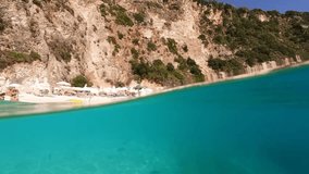 Underwater split sea level slow motion video from famous paradise beach of Agiofili in island of Lefkada, Ionian, Greece